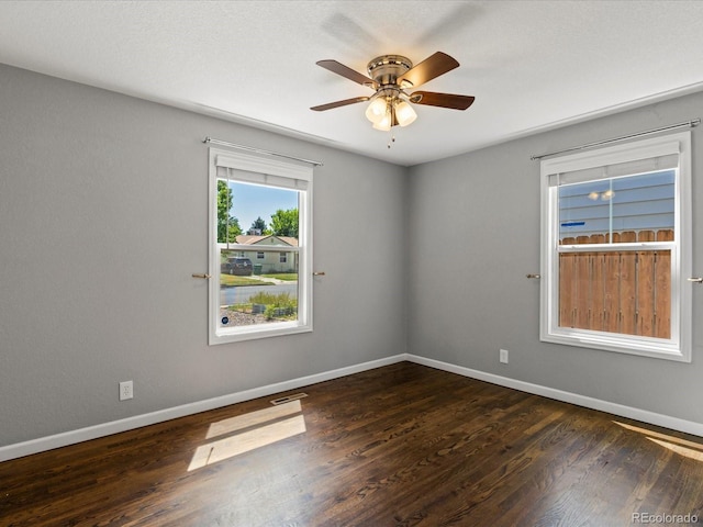 1785 Geneva St, Aurora, CO 80010 - spare room with dark wood-style floors and a ceiling fan