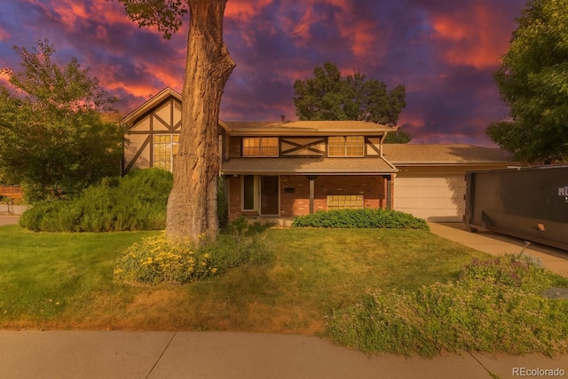 519 N Columbine St, Golden, CO 80403 - tudor-style house featuring a garage, a yard, and a porch