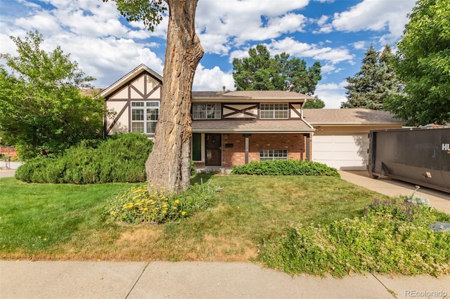 519 N Columbine St, Golden, CO 80403 - tudor home with an attached garage, a front lawn, brick siding, and concrete driveway