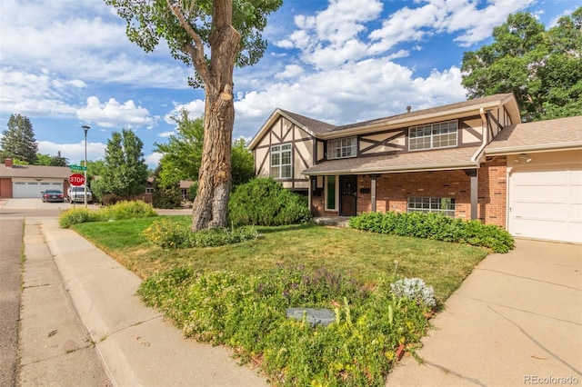 519 N Columbine St, Golden, CO 80403 - english style home featuring brick siding, driveway, a front lawn, and an attached garage