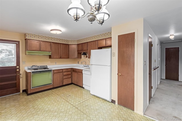 519 N Columbine St, Golden, CO 80403 - kitchen with white appliances, under cabinet range hood, light countertops, a chandelier, and light floors