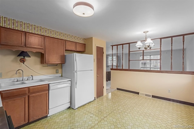 519 N Columbine St, Golden, CO 80403 - kitchen featuring white appliances, light countertops, a chandelier, light flooring, and hanging light fixtures
