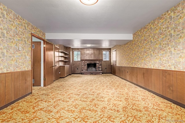519 N Columbine St, Golden, CO 80403 - unfurnished living room with wood walls, a fireplace, wainscoting, and carpet flooring
