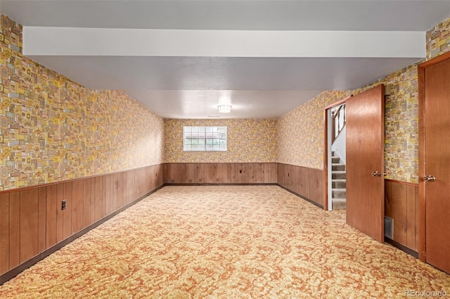 519 N Columbine St, Golden, CO 80403 - empty room with carpet floors, wainscoting, wooden walls, and stairway