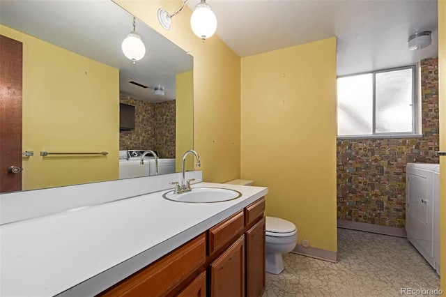 519 N Columbine St, Golden, CO 80403 - bathroom with vanity, independent washer and dryer, and tile patterned floors