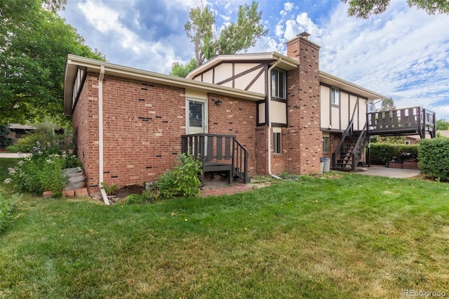 519 N Columbine St, Golden, CO 80403 - rear view of house with a chimney, stairs, a lawn, a wooden deck, and brick siding