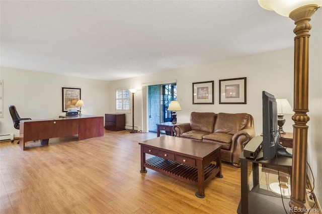 13952 E Marina Dr Unit 102, Aurora, CO 80014 - living area with light wood finished floors and a baseboard radiator