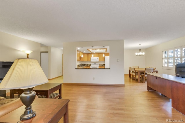 13952 E Marina Dr Unit 102, Aurora, CO 80014 - living area with light wood-type flooring and a chandelier