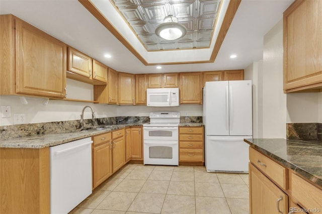 13952 E Marina Dr Unit 102, Aurora, CO 80014 - kitchen with white appliances, a tray ceiling, dark stone counters, recessed lighting, and light tile patterned floors