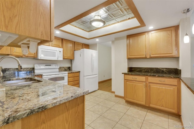 13952 E Marina Dr Unit 102, Aurora, CO 80014 - kitchen with white appliances, a tray ceiling, dark stone countertops, recessed lighting, and light tile patterned floors