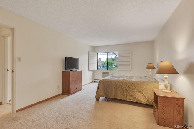 13952 E Marina Dr Unit 102, Aurora, CO 80014 - bedroom with light colored carpet, a baseboard heating unit, a textured ceiling, and a wall unit AC