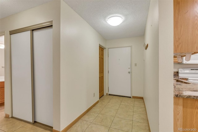 13952 E Marina Dr Unit 102, Aurora, CO 80014 - corridor featuring a textured ceiling and light tile patterned floors