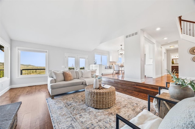 2357 Oak Ridge Rd, Sedalia, CO 80135 - living area with hardwood / wood-style flooring, a chandelier, vaulted ceiling, and french doors