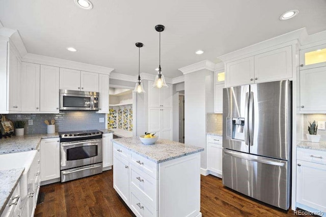 2357 Oak Ridge Rd, Sedalia, CO 80135 - kitchen with appliances with stainless steel finishes, backsplash, white cabinets, recessed lighting, and crown molding