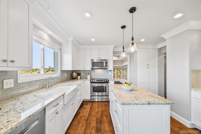 2357 Oak Ridge Rd, Sedalia, CO 80135 - kitchen with stainless steel appliances, decorative backsplash, a center island, dark wood-style floors, and white cabinets
