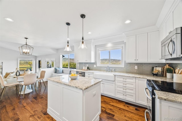 2357 Oak Ridge Rd, Sedalia, CO 80135 - kitchen with appliances with stainless steel finishes, tasteful backsplash, plenty of natural light, a kitchen island, and recessed lighting