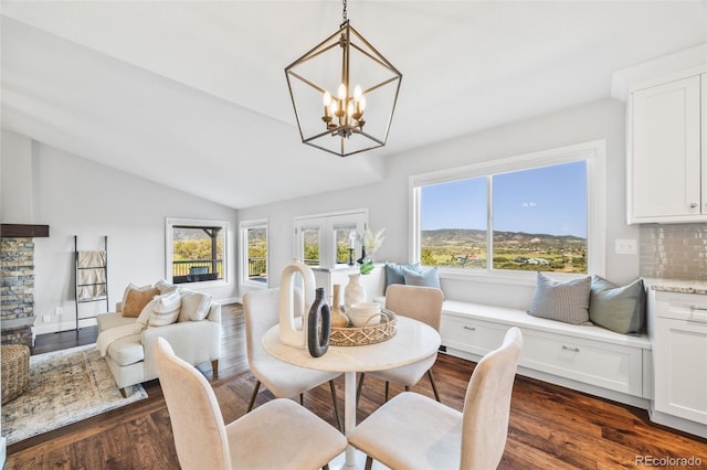 2357 Oak Ridge Rd, Sedalia, CO 80135 - dining room with a chandelier, dark wood-type flooring, and vaulted ceiling