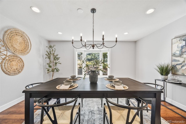 2357 Oak Ridge Rd, Sedalia, CO 80135 - dining area with wood finished floors, a chandelier, and recessed lighting