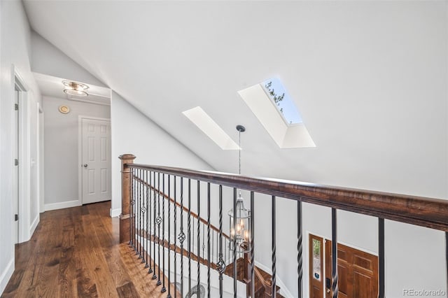 2357 Oak Ridge Rd, Sedalia, CO 80135 - hallway with lofted ceiling, a skylight, an upstairs landing, and wood finished floors