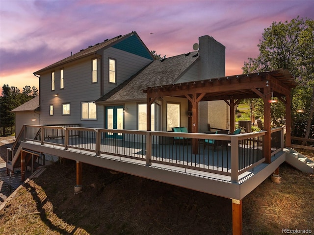 2357 Oak Ridge Rd, Sedalia, CO 80135 - back of house at dusk with a shingled roof, a deck, a chimney, and a pergola