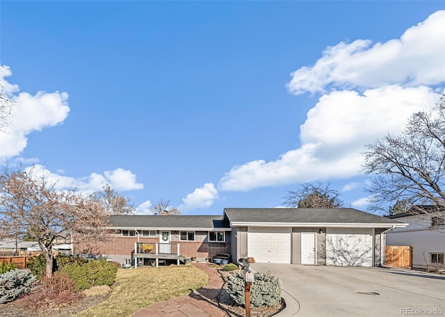 single story home featuring driveway, brick siding, an attached garage, and fence