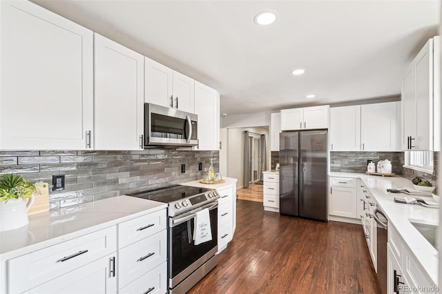 kitchen with white cabinets, stainless steel appliances, dark wood-style flooring, and recessed lighting