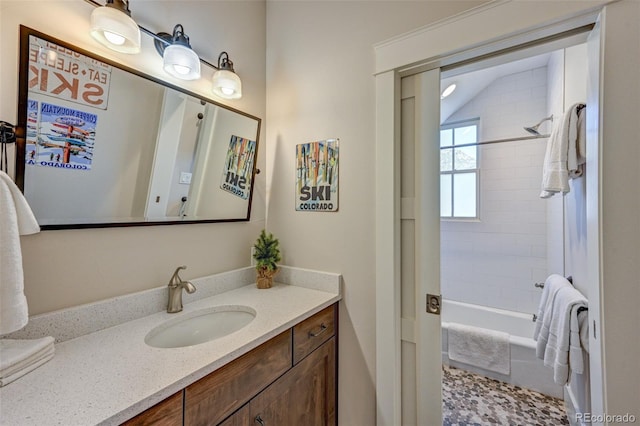 bathroom featuring vanity and tiled shower / bath