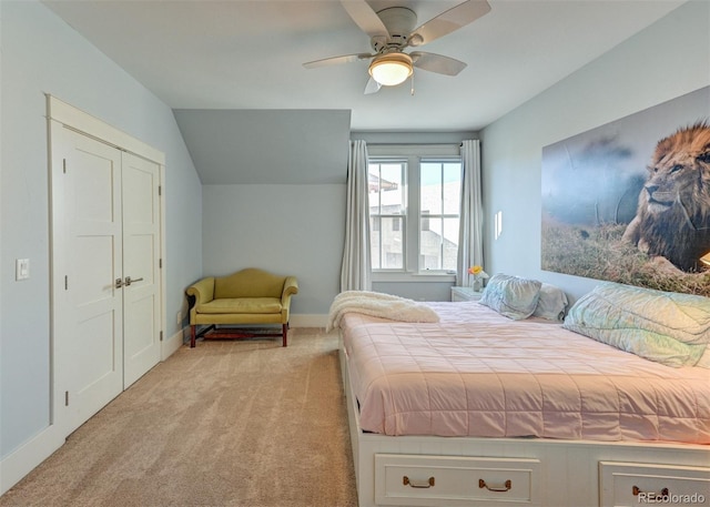 carpeted bedroom featuring ceiling fan and a closet