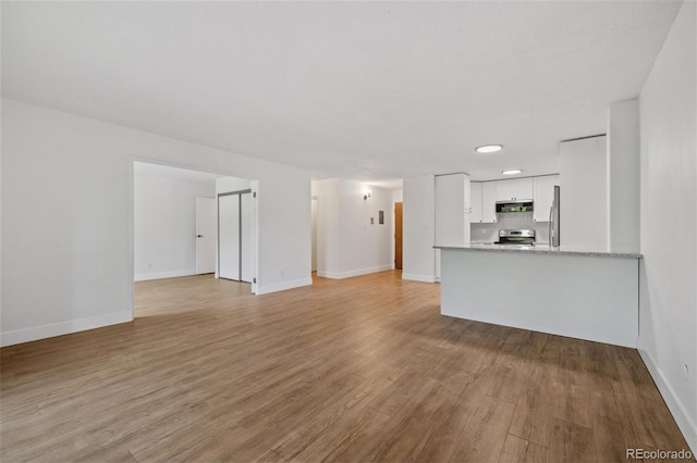 unfurnished living room featuring light wood-type flooring