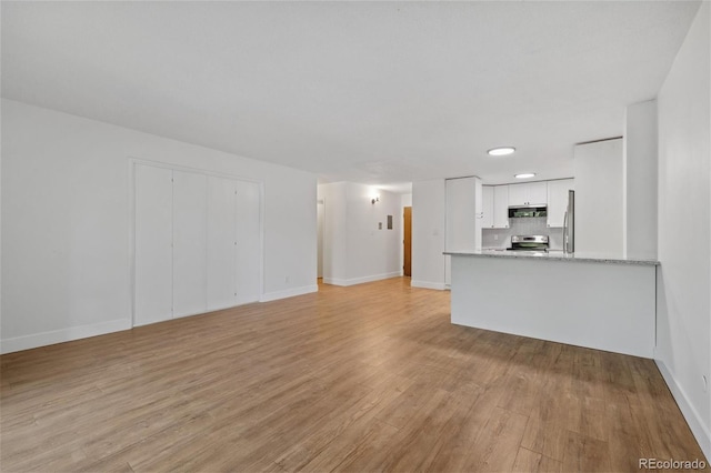 unfurnished living room with light wood-type flooring