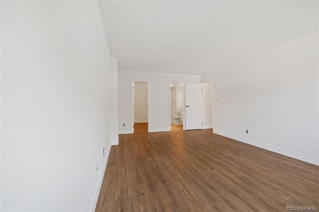 unfurnished living room featuring hardwood / wood-style flooring