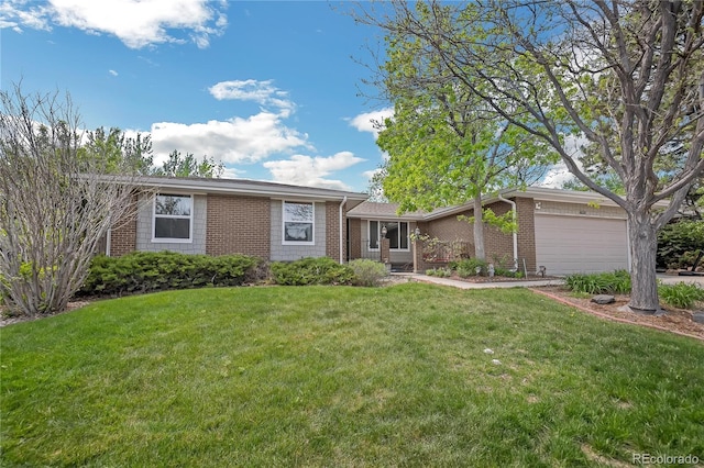 8150 W Calhoun Dr, Littleton, CO 80123 - view of front facade with brick siding, an attached garage, and a front lawn