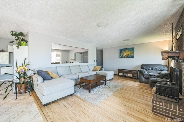 8150 W Calhoun Dr, Littleton, CO 80123 - living area featuring a fireplace, a textured ceiling, and light wood finished floors