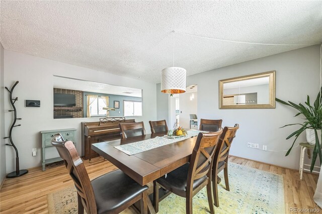 8150 W Calhoun Dr, Littleton, CO 80123 - dining space featuring wood finished floors and a textured ceiling