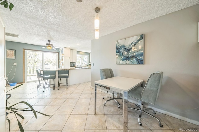8150 W Calhoun Dr, Littleton, CO 80123 - dining room with a textured ceiling, light tile patterned floors, and ceiling fan