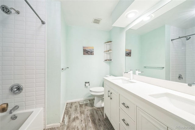 8150 W Calhoun Dr, Littleton, CO 80123 - bathroom with wood finished floors, toilet, shower / tub combination, and baseboards