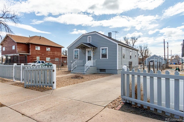 bungalow-style home with a fenced front yard