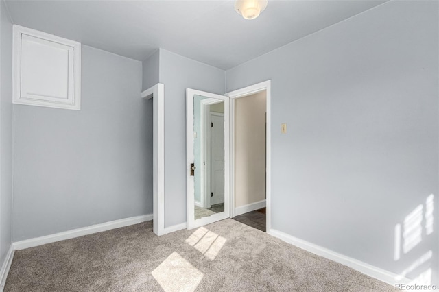 unfurnished bedroom with carpet flooring and baseboards