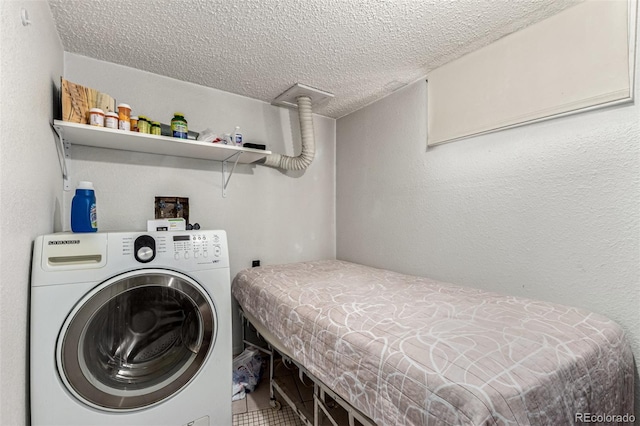 washroom with laundry area, washer / clothes dryer, a textured ceiling, and a textured wall