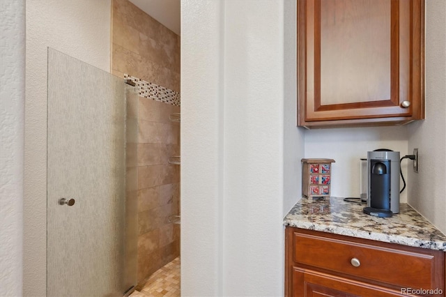 bathroom featuring vanity and a tile shower