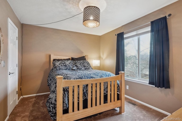 carpeted bedroom featuring visible vents and baseboards