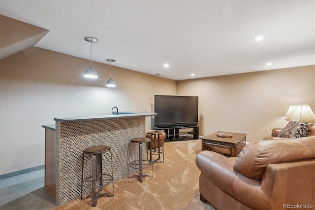 living area with indoor wet bar, recessed lighting, and light colored carpet