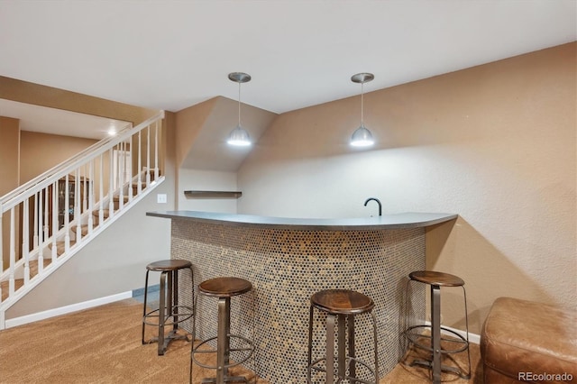 bar featuring pendant lighting, wet bar, carpet floors, baseboards, and stairs