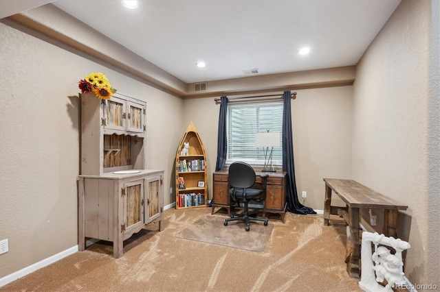 office space with carpet, visible vents, and baseboards