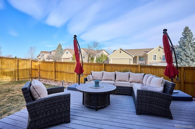 deck with a residential view, an outdoor living space, and a fenced backyard