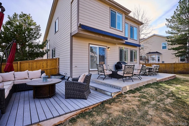 rear view of house with an outdoor living space, a wooden deck, and fence