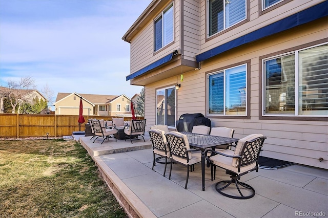 view of patio with outdoor dining area and fence