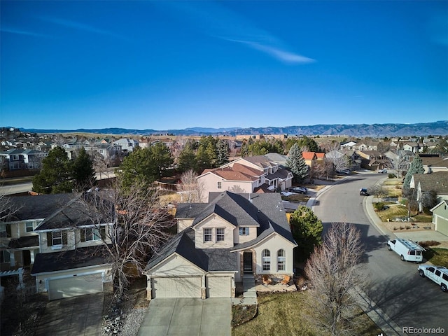 birds eye view of property with a mountain view and a residential view