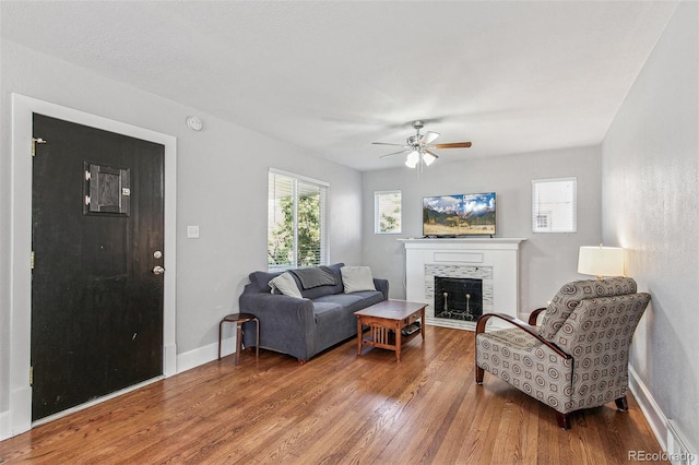 living room with hardwood / wood-style flooring and ceiling fan