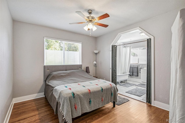 bedroom featuring ceiling fan, hardwood / wood-style flooring, and ensuite bathroom